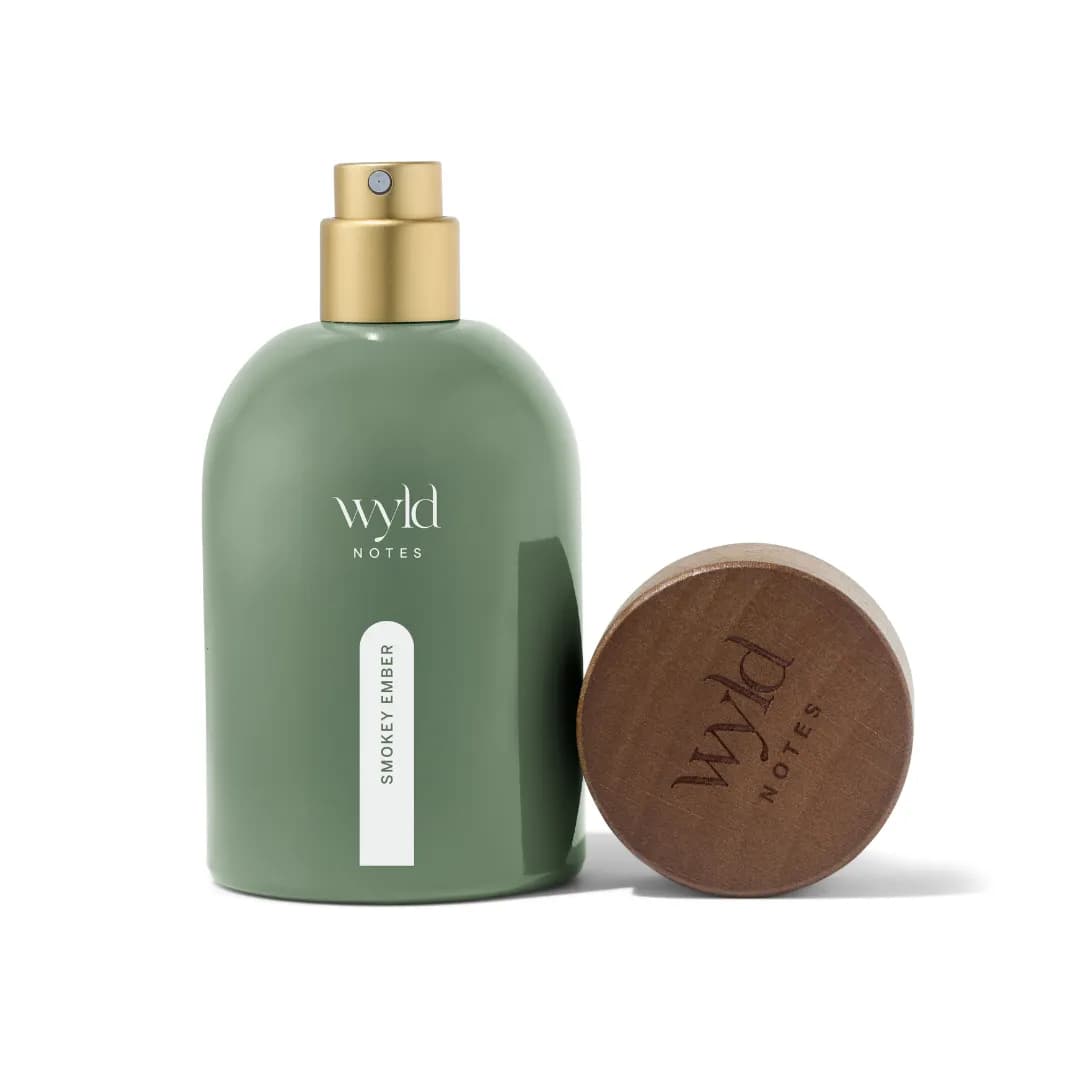 Wyld Notes bottle with its wooden cap set aside on a light background